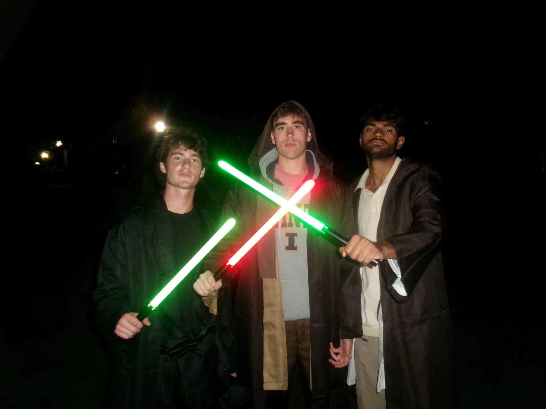 PCT family posing with glowing lightsabers