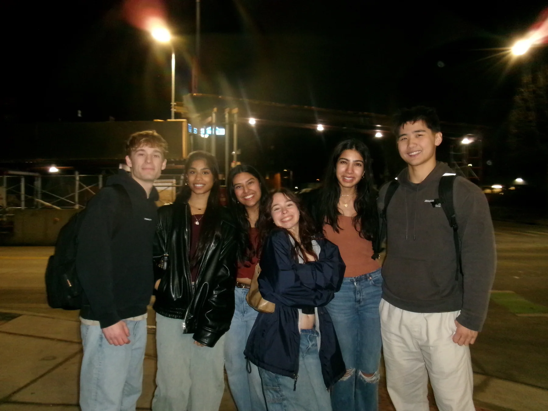 Five PCT friends together outdoors at night